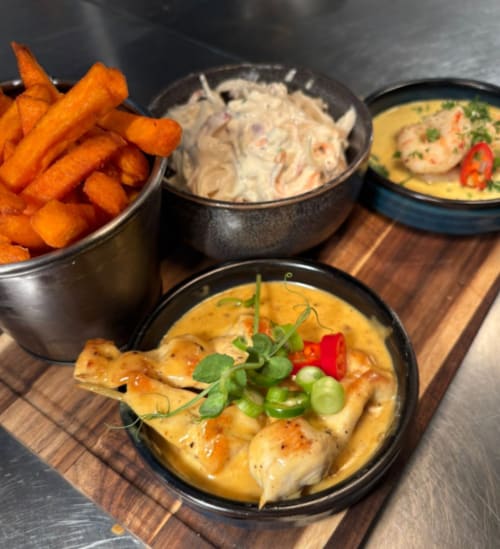 Gourmet seafood meal at The Old Kings Head, Kirton: shrimp curry, creamy pasta, and crispy sweet potato fries.