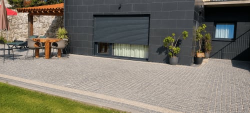 Pátio moderno da Casa Carvalho, Serração House Gerês, com terraço pavimentado, mobiliário e plantas em vasos