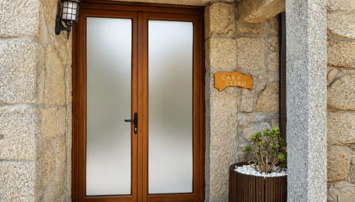 Portas duplas de madeira com painéis de vidro fosco na entrada da casa de hóspedes Casa Cedro, Gerês, Rio Caldo Portugal
