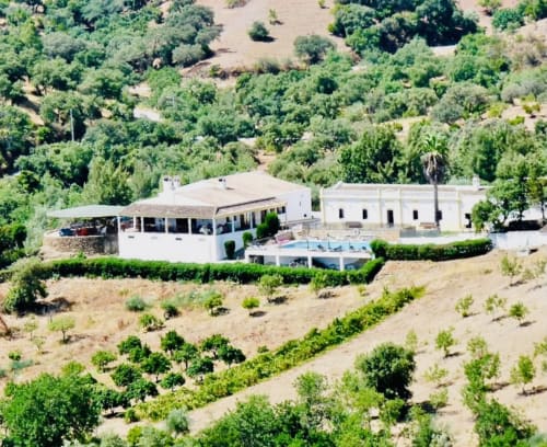Vista aérea do hotel rural Herdade da Côrte com edifícios brancos, piscina e vinhedos em Tavira, Portugal