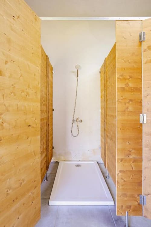 Modern shower room with wooden walls, rainfall showerhead, and white basin in a 6-bedroom villa in Chaves, Portugal