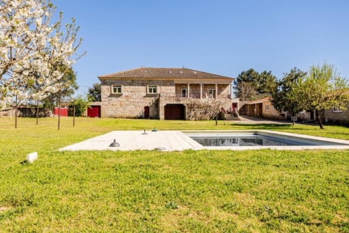 Stone villa in Chaves with garden, pool, and terrace surrounded by lush green lawn