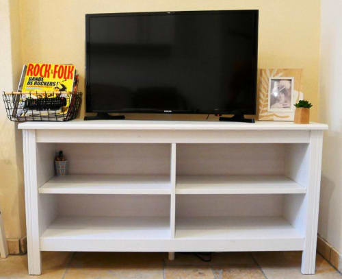 Meuble TV blanc avec téléviseur écran plat et étagères de rangement dans l'appartement Le Travertin Studio à Avignon.