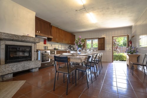 Cozinha e sala de jantar espaçosas na Quinta de Carvalhal com lareira, vistas para o jardim e acomodação para seis pessoas
