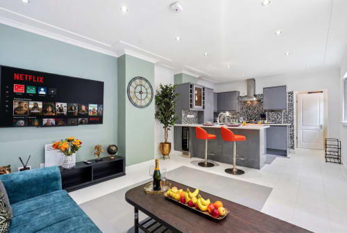Modern apartment at 11.11 Property Estates, Birmingham with open-plan kitchen, living area, Netflix TV, and city views