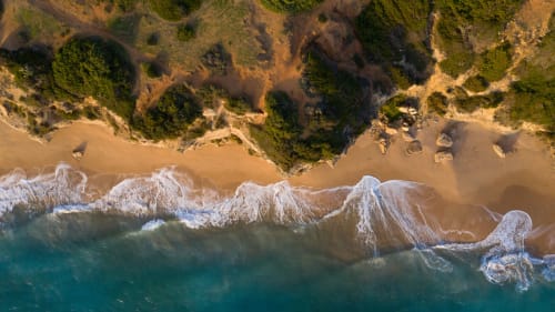 Aerial view of turquoise waves and sandy beach near Casa De La Cruz Vejer, Cádiz Spain