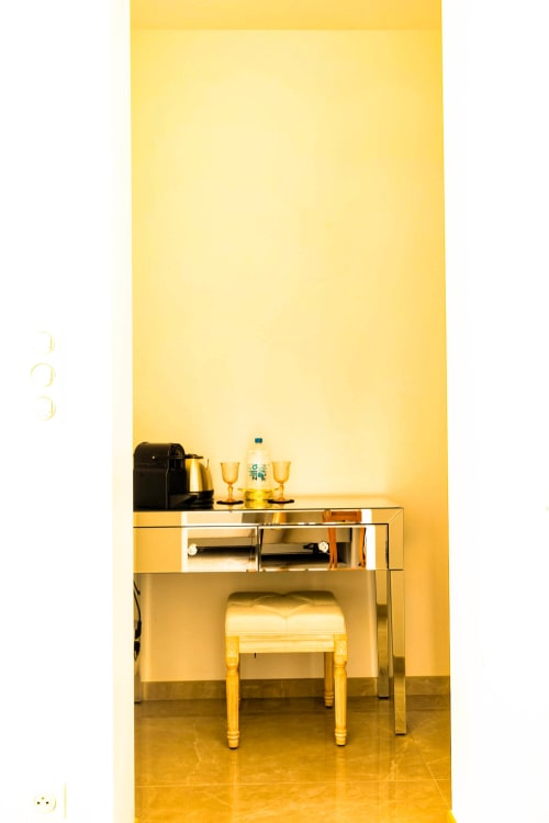Modern hotel room desk with mirror at Hôtel Villa Martini, Ajaccio, featuring coffee maker and amenities