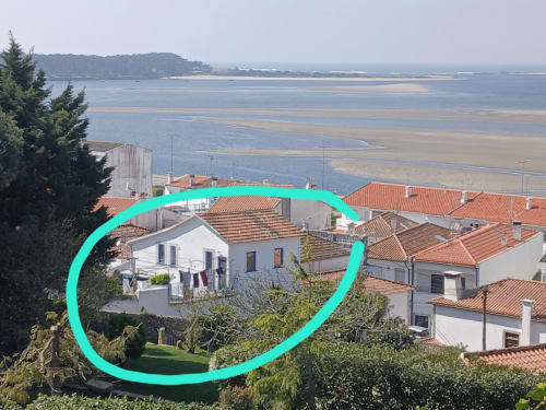 Bom Caminha hostel in Caminha, Portugal with coastal estuary views, white and terracotta-roofed buildings surrounded by green