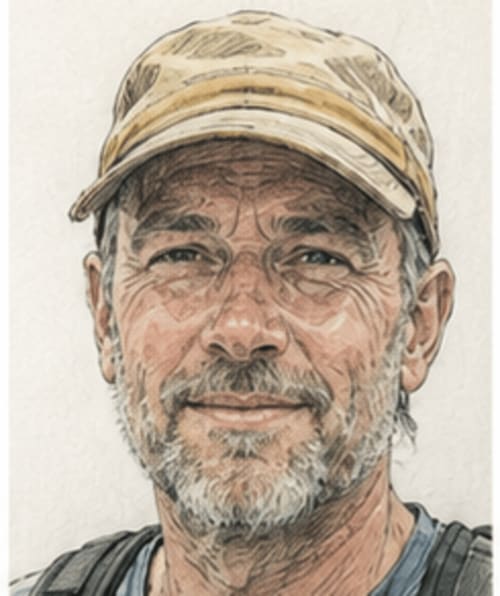 Older man with white beard wearing tan cap at Bom Caminha hostel in Caminha, Portugal