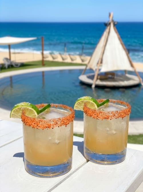 Two spicy margaritas with lime garnish at Vidasoul beachfront bar, La Vinorama Mexico