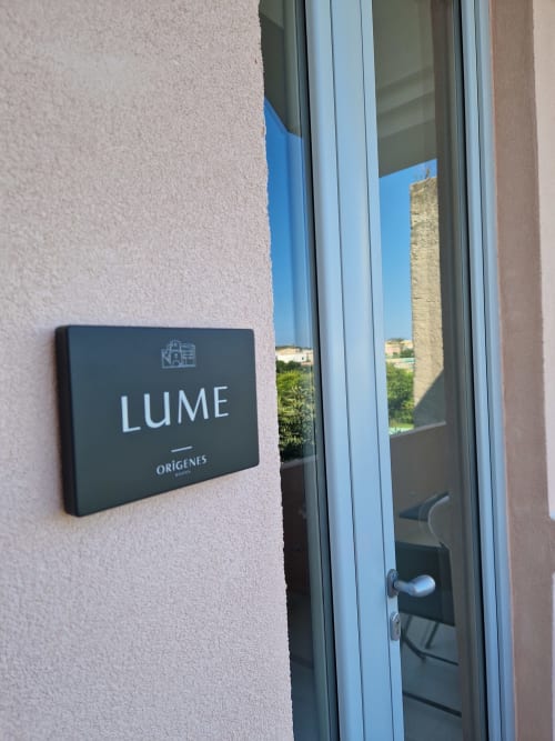 Insegna della camera Lume presso Origenes Rooms bed and breakfast a Procida, Italia, con vista mare visibile attraverso la porta in vetro