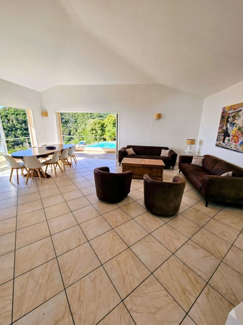 Modern villa living room with sea view pool at Corsu Di Core, Favone - open plan lounge with sofas