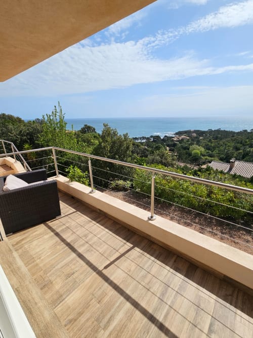 Villa Eva terrace with sea view, railing, lounge furniture overlooking Mediterranean at Corsu Di Core, Favone