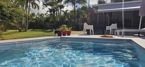 Swimming pool at Habitation Villa Les Cassias in Petit Bourg, Guadeloupe, with tropical gardens and modern bungalow