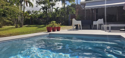 Tropical pool at Habitation Villa Les Cassias in Guadeloupe, with lounge chairs and lush gardens