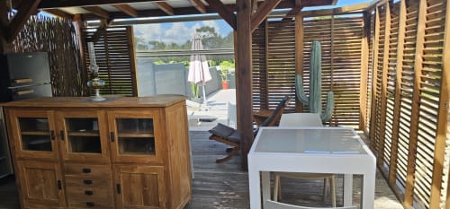 Bungalow Néo at Habitation Villa Les Cassias with wooden shutters, pool view, and modern amenities in Petit Bourg, Guadeloupe