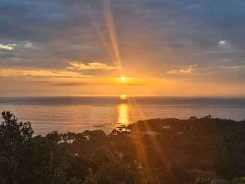 Sunset view over the Mediterranean Sea from Villa Eva at Corsu Di Core, Favone, France, with golden light reflecting on water