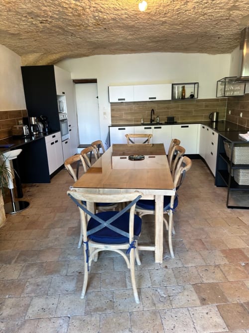 Cuisine et salle à manger modernes de la Maison Melrose à Vouvray avec mobilier blanc, table en bois et plafond rustique