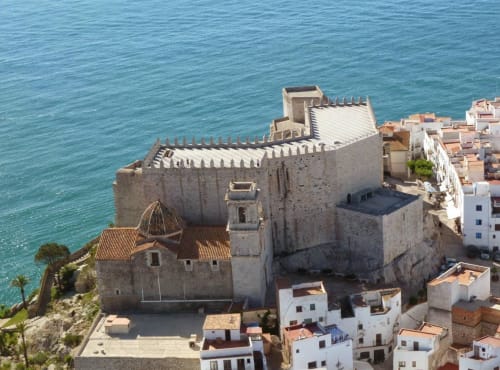 Medieval castle overlooking turquoise sea in Peñíscola, Spain near Jardines de Plaza apartments