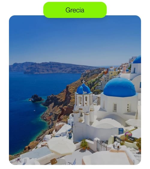 Whitewashed buildings with blue domes overlook the Aegean Sea in Greece