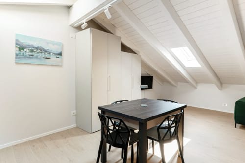 Mansarda moderna presso Lago Suites Como con tavolo da pranzo, armadio incorporato, lucernario e opere d'arte marina