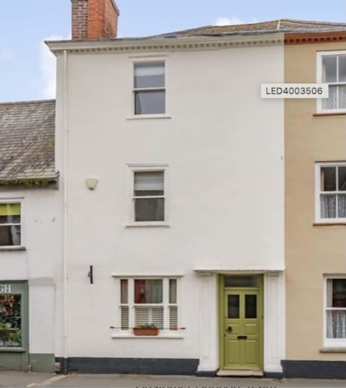White terraced villa at 24 Fore Street, Topsham, Exeter with lime green door and period windows