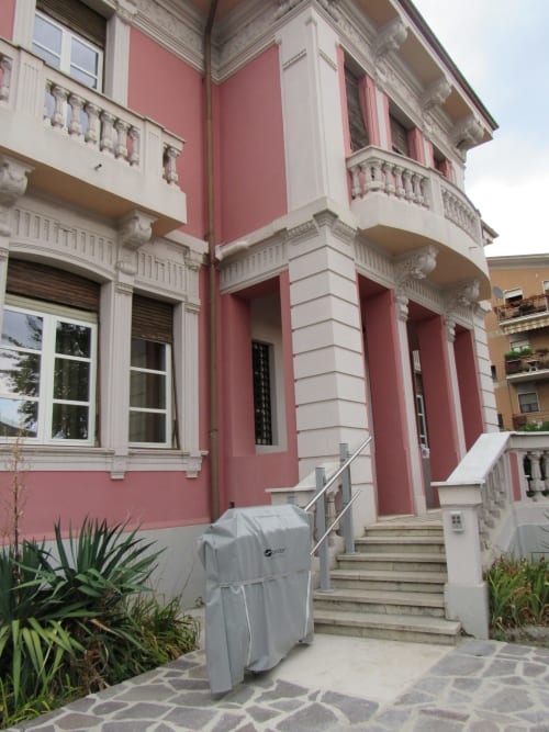 Ingresso del B&B Il 900 ad Avezzano con facciata neoclassica rosa e bianca, scale e balconate ornamentali