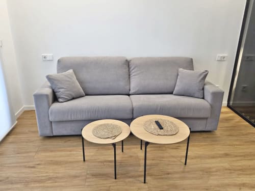 Moderna sala de estar en BR Silgar Club de Sanxenxo con sofá gris y mesas auxiliares de madera