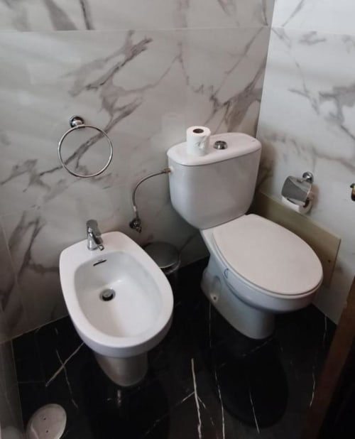 Modern bathroom at Hotel Slow Stay Esposende with bidet, toilet, and marble walls