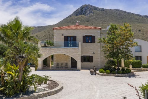 Villa Freedom B&B entrance in Kokkino Chorio, Crete with stone architecture and mountain backdrop