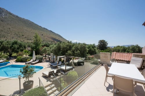 Villa Freedom terrace with pool, loungers, and mountain views in Kokkino Chorio, Crete