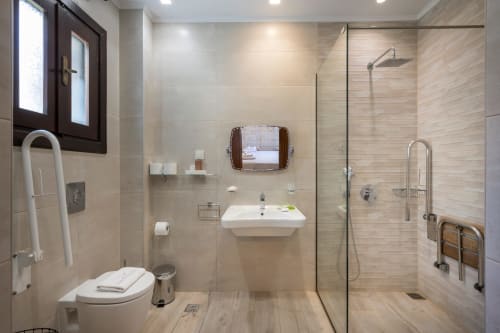 Modern bathroom at Villa Freedom in Crete with walk-in shower, white sink, and heated towel rail