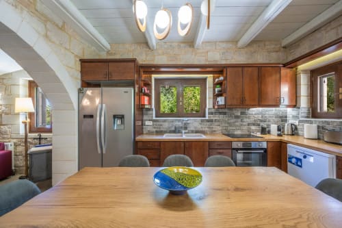 Modern kitchen with wooden dining table at Villa Freedom, Kokkino Chorio, Crete