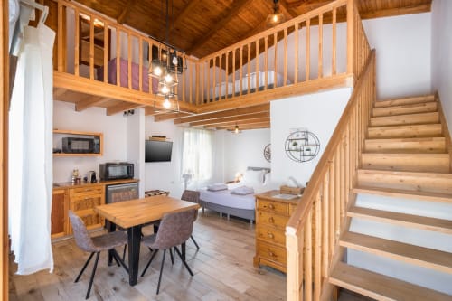 Villa Freedom studio loft in Kokkino Chorio, Crete with wooden mezzanine, kitchenette, and bed area