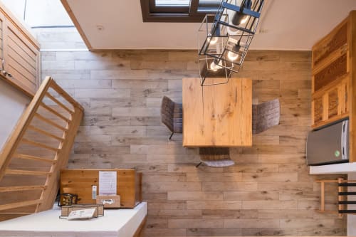 Aerial view of Villa Freedom dining area with wooden table, chairs, and kitchen in Kokkino Chorio, Crete