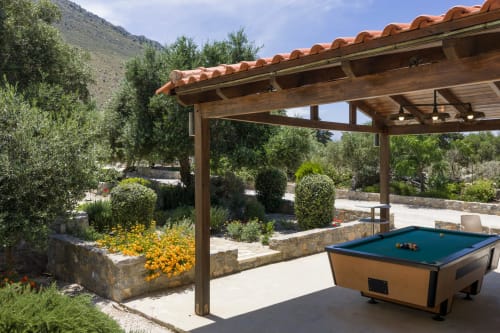 Pool table under wooden pergola in Villa Freedom's garden, Kokkino Chorio Crete, with olive trees and mountain views