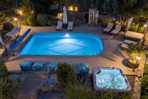 Villa Freedom pool at night in Kokkino Chorio, Crete with illuminated swimming pool, hot tub, and loungers