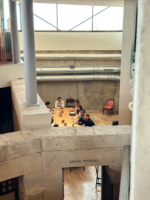 Réunion d'affaires au Salon Promenade de l'Hôtel La Prison à Béziers, avec architecture en pierre et verrière