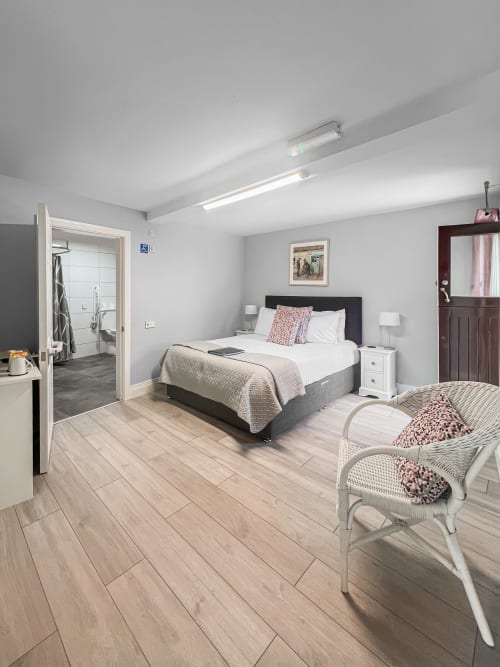 Modern double bedroom at Madeline's Accommodation in Wicklow with en-suite bathroom, mountain views, and contemporary