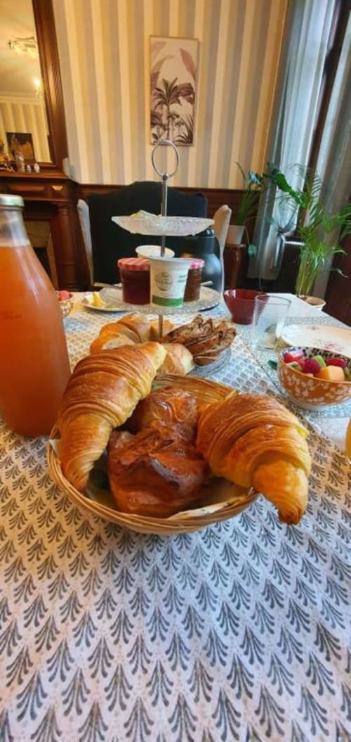 Petit-déjeuner continental au Manoir de Saint-Ouen avec croissants, pâtisseries, jus d'orange, fruits frais et confitures