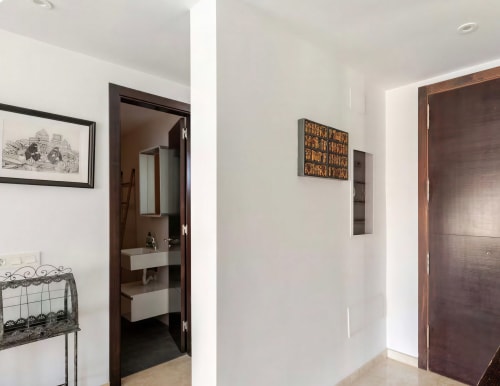 Modern hallway in Sweet Green 21 villa at Home Stay Gran Canaria with dark wood doors and white walls