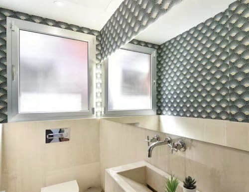 Modern bathroom in SWEET GREEN 21 villa at Home Stay Gran Canaria with dual mirrors, geometric wallpaper, and contemporary