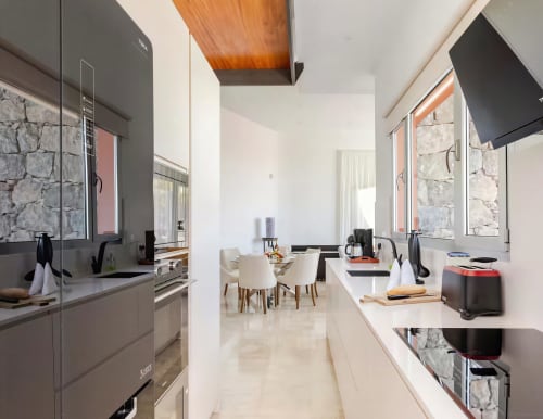 Modern kitchen with white countertops and dark cabinetry in Sweet Green 21 villa at Home Stay Gran Canaria
