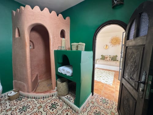 Salle de bain marocaine avec douche tour en tadelakt rose et murs verts à l'hôtel Eucalyptus Ethnic, Essaouira