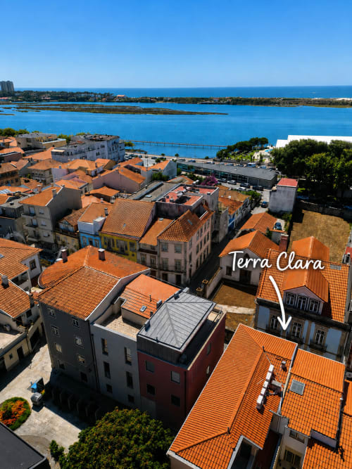 Vista aérea de Terra Clara Studios com telhados de barro e águas azuis em Esposende, Portugal