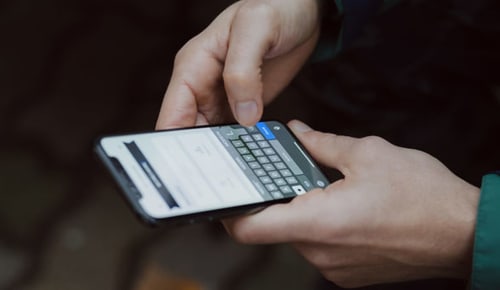 Guest using smartphone with calculator app at La Borda del Gato Rafa hotel in Vielha
