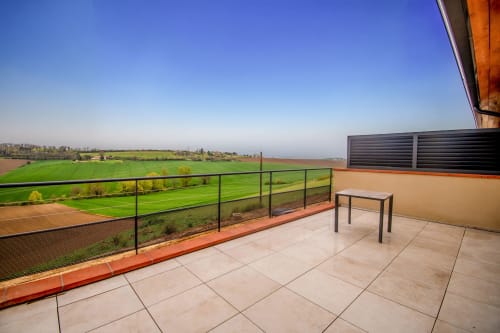 Spacious terrace at Lieu-dit Boulage hotel studio in Marquefave with panoramic rural views, table seating, and countryside