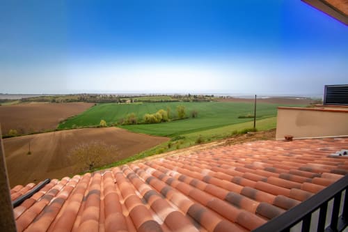Terracotta rooftop overlooking rolling farmland near Marquefave, France from Lieu-dit Boulage hotel