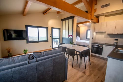 Modern Premium apartment at Lieu-dit Boulage with open living area, kitchen, dining space and bedroom with mountain views
