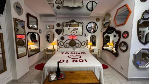 Camera romantica con specchi decorati, cuori e dettagli rossi presso la Farm B&B Pupi Catania ad Aci Castello, Italia